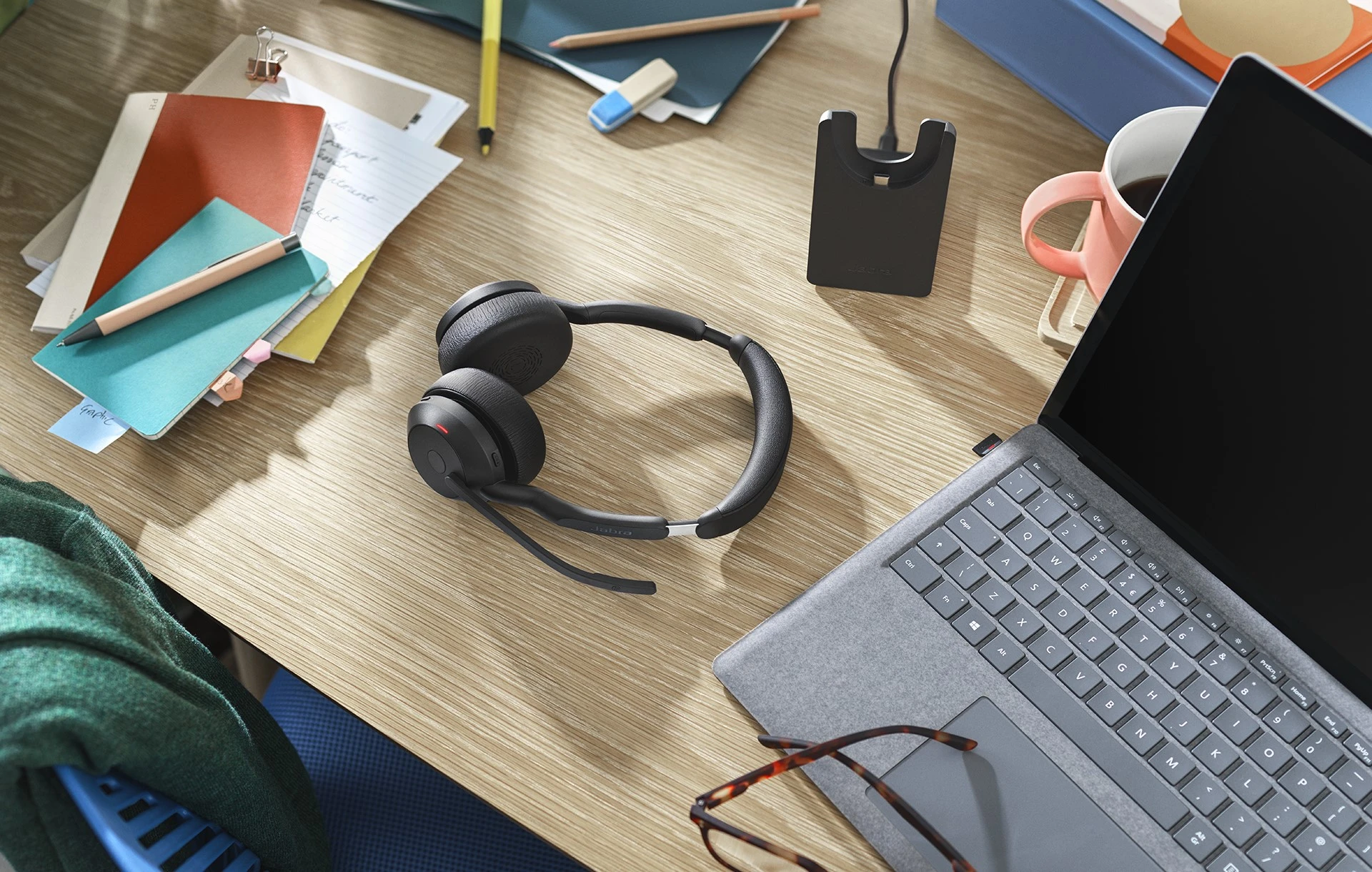 Jabra Evolve2 55 headset on cluttered office desk